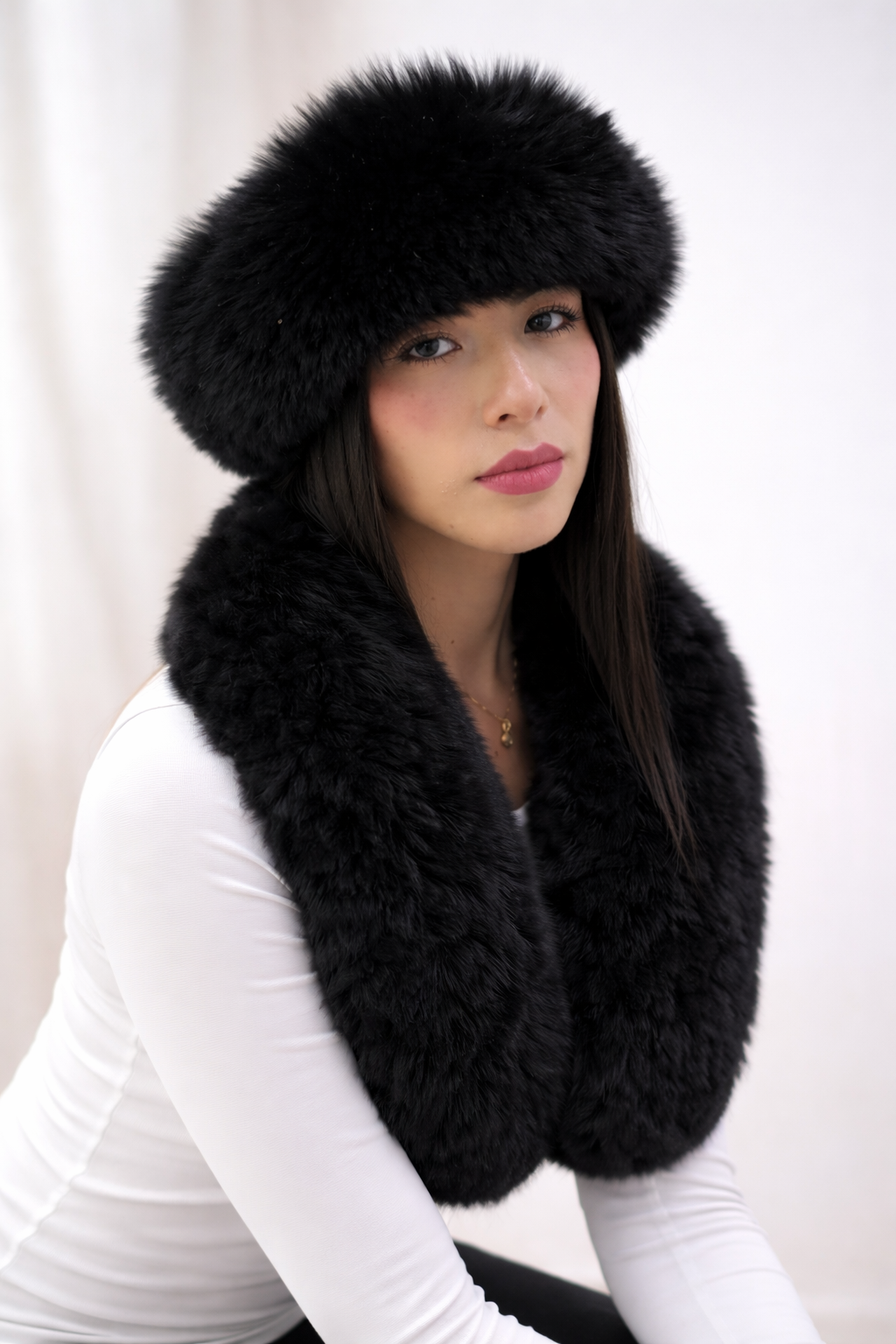 Black baby alpaca fur earmuffs and matching alpaca fur scarf worn by model on white background – handmade in Peru by Qoriquna Alpaca Atelier